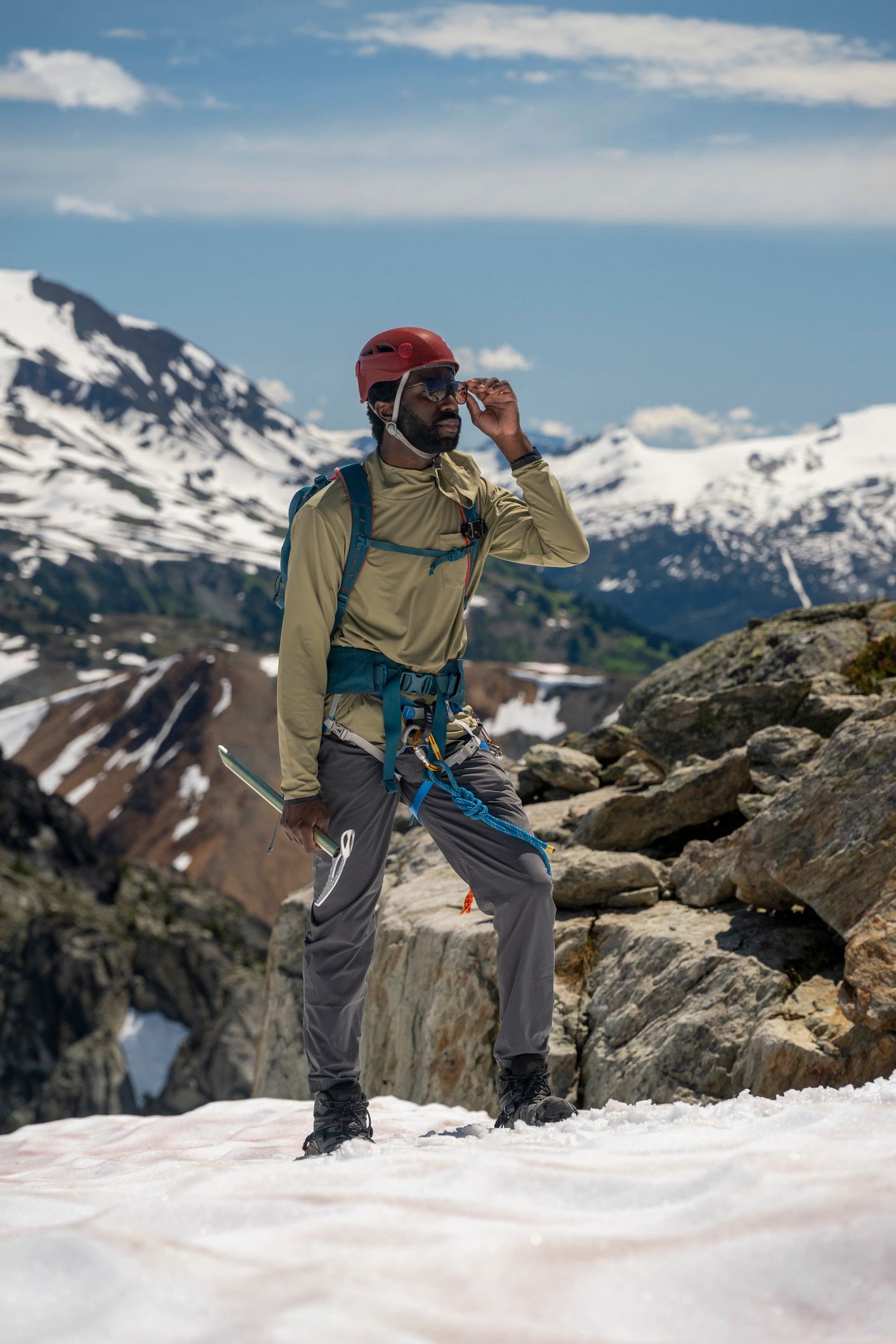 Mountain guide standing on a summit ridge