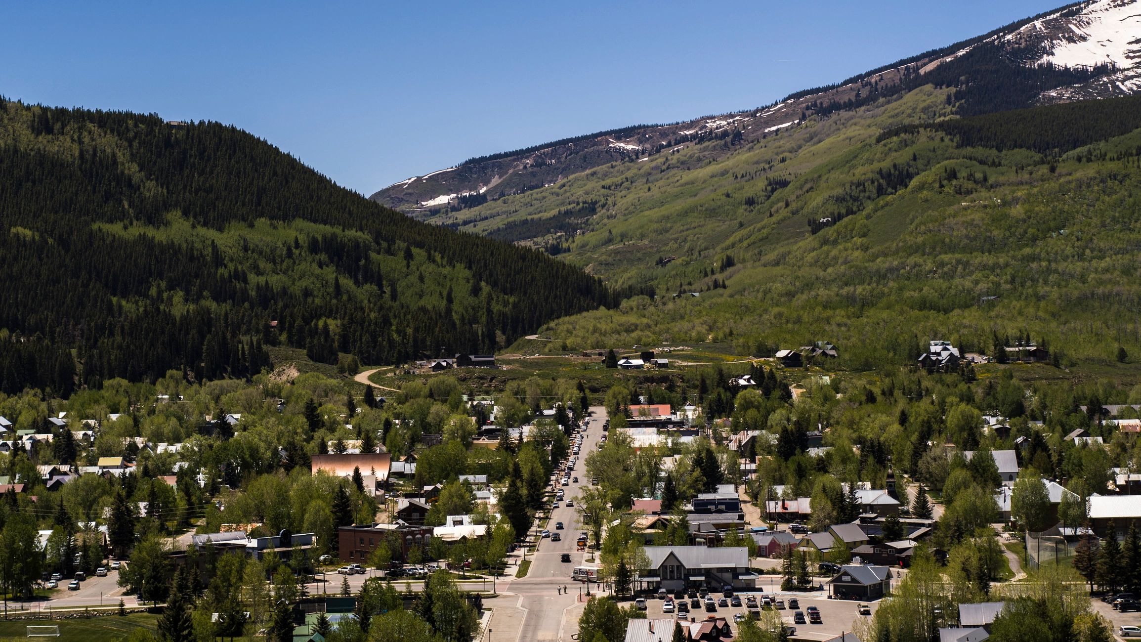 Aerial view of a mountain town surrounded by Rocky Mountains
